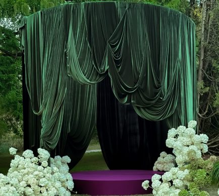 Olive Green draping set up in a circular canopy in a outside setting