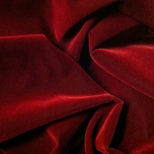 Deep red velvet draping adding a rich, dramatic, and luxurious touch to an event setting