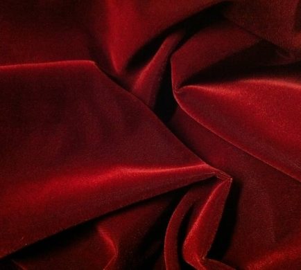 Deep red velvet draping adding a rich, dramatic, and luxurious touch to an event setting