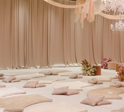 Beige bridal satin draping creating a sophisticated and romantic backdrop for a wedding event
